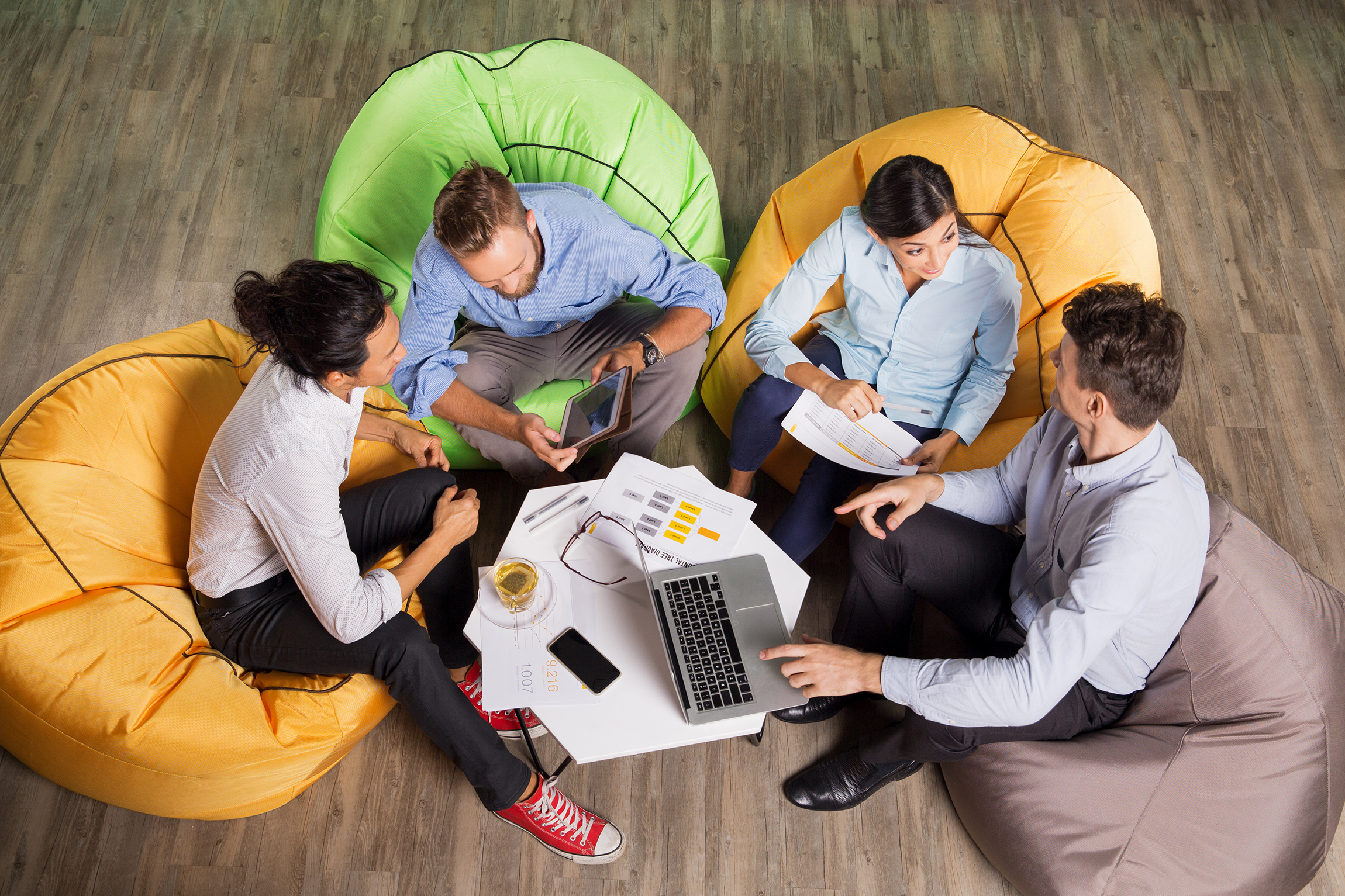 People Discussing Ideas and Sitting at Cafe Table